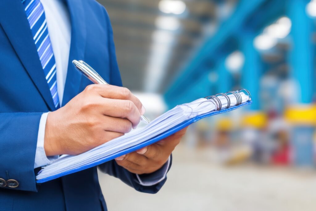 a professional checks technical standards manual, ensuring compliance and quality control in a vibrant factory environment